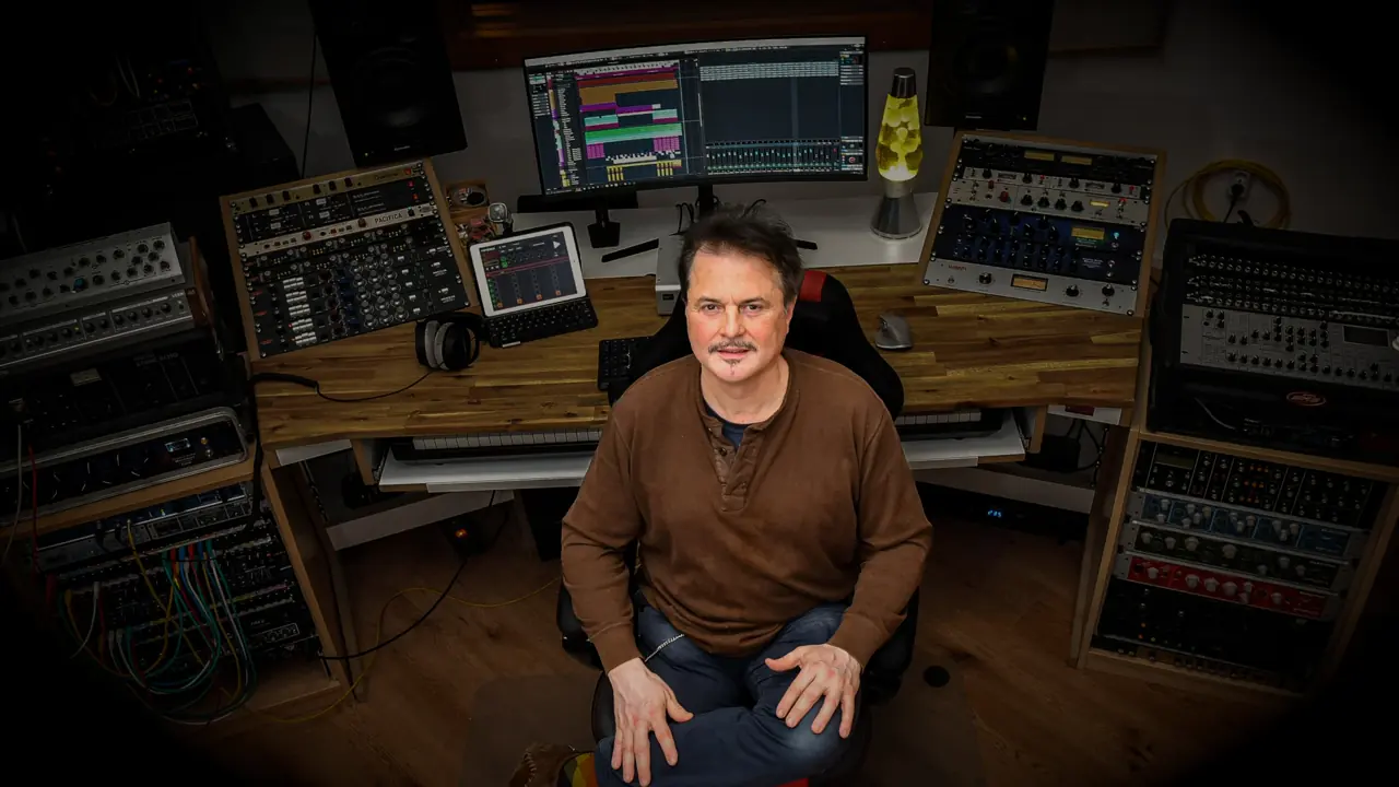 Producer seated at the Hot Milk Studio console, surrounded by outboard racks, monitors and a session in progress.